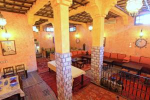 a large room with a fireplace in a building at Riad Nezha in Merzouga