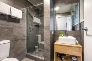 a bathroom with a sink and a shower at Nightcap at Sylvania Hotel in Campbellfield