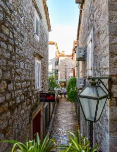 an alley way between two buildings with a street light at Sea Paradise Apartment in Budva