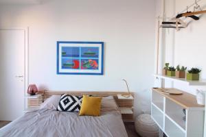 a bedroom with a bed and a desk at Seaview Apartments in Palermo