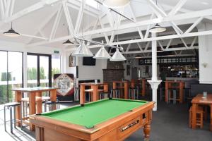 a pool table in a room with a bar at Fernlodge Inglewood in Inglewood