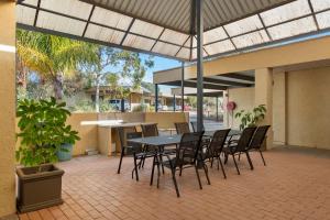 a patio with a table and chairs in a building at Comfort Inn & Suites Riverland in Barmera