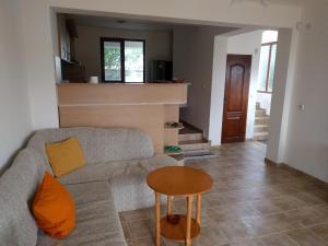 a living room with a couch and a table at Villa Visoka in Balchik