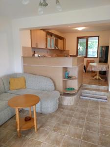 a living room with a couch and a table at Villa Visoka in Balchik