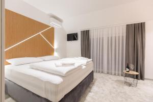 Säng eller sängar i ett rum på Apartmani i sobe Pejačević