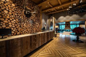 a lobby with a large wall of logs at Kensington Resort Seorak Valley in Sokcho