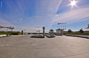 a clock tower in the middle of a plaza with flags at Pension Villa Seefrieden in Binz