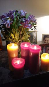 a group of candles on a table with a vase of flowers at Le dernier métro in Brussels