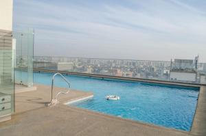a swimming pool with a view of a city at Austral Rentahome Nueva Providencia in Santiago