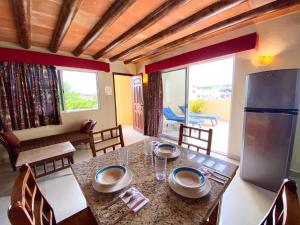 a kitchen and dining room with a table and a refrigerator at Hotel El Campanario Playa del Carmen in Playa del Carmen