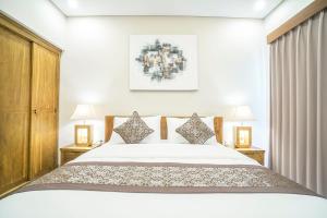 Postel nebo postele na pokoji v ubytování Putih DCarik Ubud