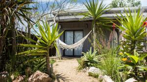 a house with a hammock in the garden at Studio Cabin I in José Ignacio