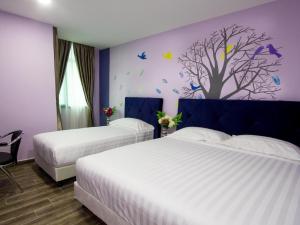 Postel nebo postele na pokoji v ubytování Elmark Hotel Johor