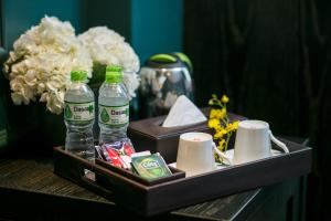 a tray with drinks and other items on a table at Grande Collection Hotel & Spa in Hanoi