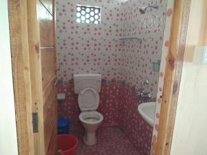 a bathroom with a toilet and a sink at Cola Beach Sunset Bay in Cola