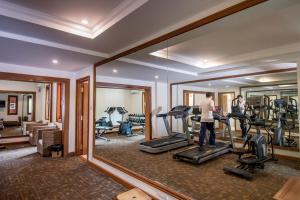a man exercising in a gym with a mirror at Heritage Bagan Hotel in Bagan
