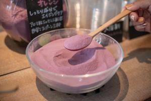 a person is stirring a bowl with a spoon at Uwajima Oriental Hotel in Uwajima