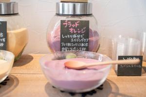 a bowl of food with a wooden spoon in it at Uwajima Oriental Hotel in Uwajima