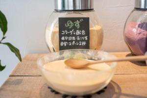 a bowl of food on a table with a spoon at Uwajima Oriental Hotel in Uwajima