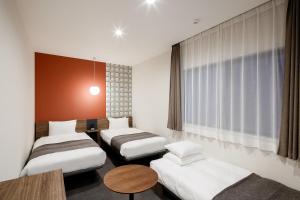 Säng eller sängar i ett rum på M's Hotel Kyoto Station Kizuya