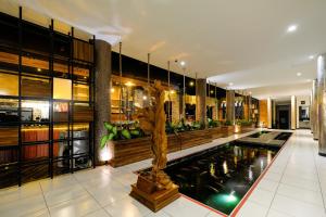 a lobby with a pool in the middle of a building at Papillon Echo Beach in Canggu