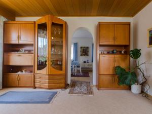 a large room with wooden cabinets and a living room at Ferienwohnung Hertel in Mistelgau