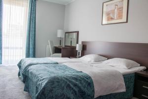 Łóżko lub łóżka w pokoju w obiekcie Apartamenty Aquarius z Aquacenter