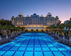 a view of the resort from the pool at dusk at Rubi Platinum Spa Resort & Suites in Avsallar