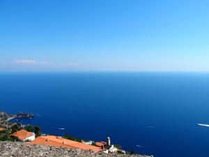 a view of the ocean and a town on a hill at GIARDINO SUL MARE in Amalfi