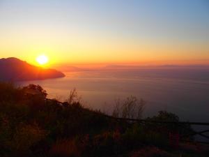a sunset on a hill with a view of the ocean at GIARDINO SUL MARE in Amalfi