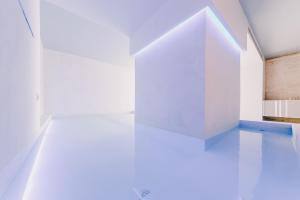 Habitación vacía con paredes blancas y suelo azul. en Suite 10 Home Design & Spa en Polignano a Mare