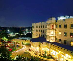 a large building at night with the lights on at Forbis Hotel in Serang