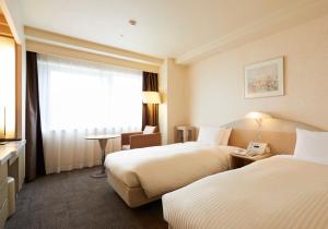 Postel nebo postele na pokoji v ubytování Kawagoe Prince Hotel