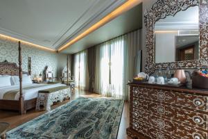 a bedroom with a large bed and a large mirror at AJWA Sultanahmet in Istanbul