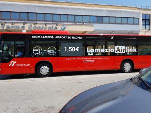 a double decker bus parked in front of a building at Guest House Lamezia Airport in Lamezia Terme