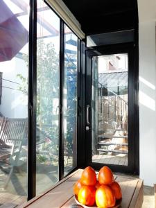 a pile of oranges on a table in front of a window at Guesthouse in Picture in Jeonju