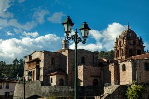 an old building with a street light in front of it at San Agustin Plaza in Cusco