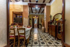 a dining room with a table and a tv at La Casona Albaida in Albaida