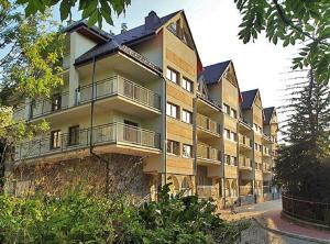 a large building with balconies on the side of it at Apart-Center Motyl in Zakopane