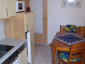 a kitchen with a table and a small table and a table and chairs at Annettes Ferienstübchen in Bad Berka