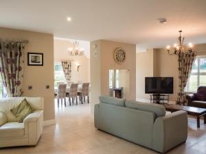 a living room with two couches and a tv at The Willows at Mullans Bay in Kesh