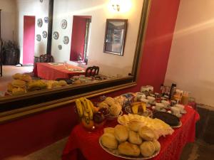 a table in front of a mirror with food on it at Quinta Da Lagoa GuestHouse in Vila Real +6 photos