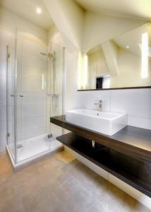 a bathroom with a tub and a sink and a shower at Hotel Tenbrock - Restaurant 1905 in Gescher