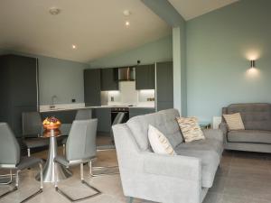 a living room with a couch and a table at Executive Lakeside Lodge at Mullans Bay in Kesh