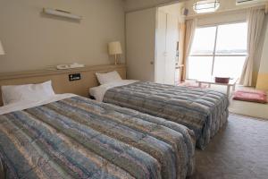 Postel nebo postele na pokoji v ubytování Hotel Listel Hamanako