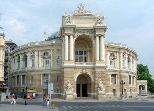 a large building with people walking in front of it at Vip Apartment na Derebasovskoi in Odesa