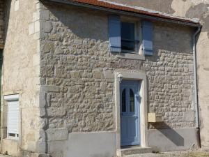 a stone house with a blue door and a window at Simple Life House in Saint-Maurice-sous-les-Côtes