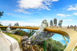 a statue of a hand holding up a bridge at TONY ESTATES Danang Beach Luxury Apartments in Danang