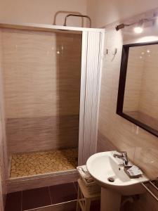 a bathroom with a sink and a shower at Dei Gerolomini in Naples