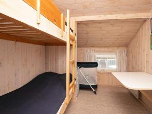 a small room with bunk beds in a cabin at Simplistic Holiday Home in Jutland with Swimming Pool in Løkken